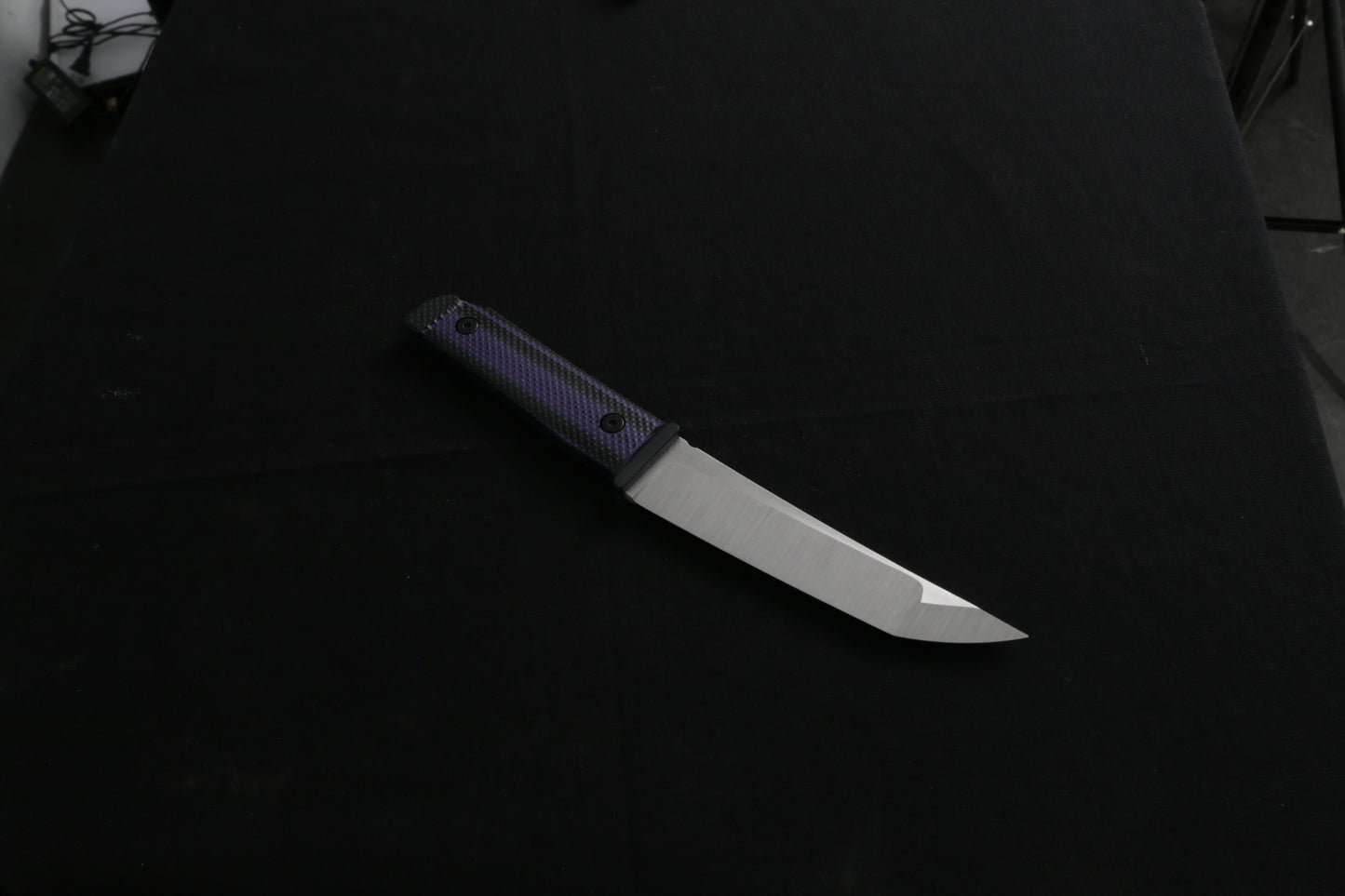 Knife with a black handle on a dark background