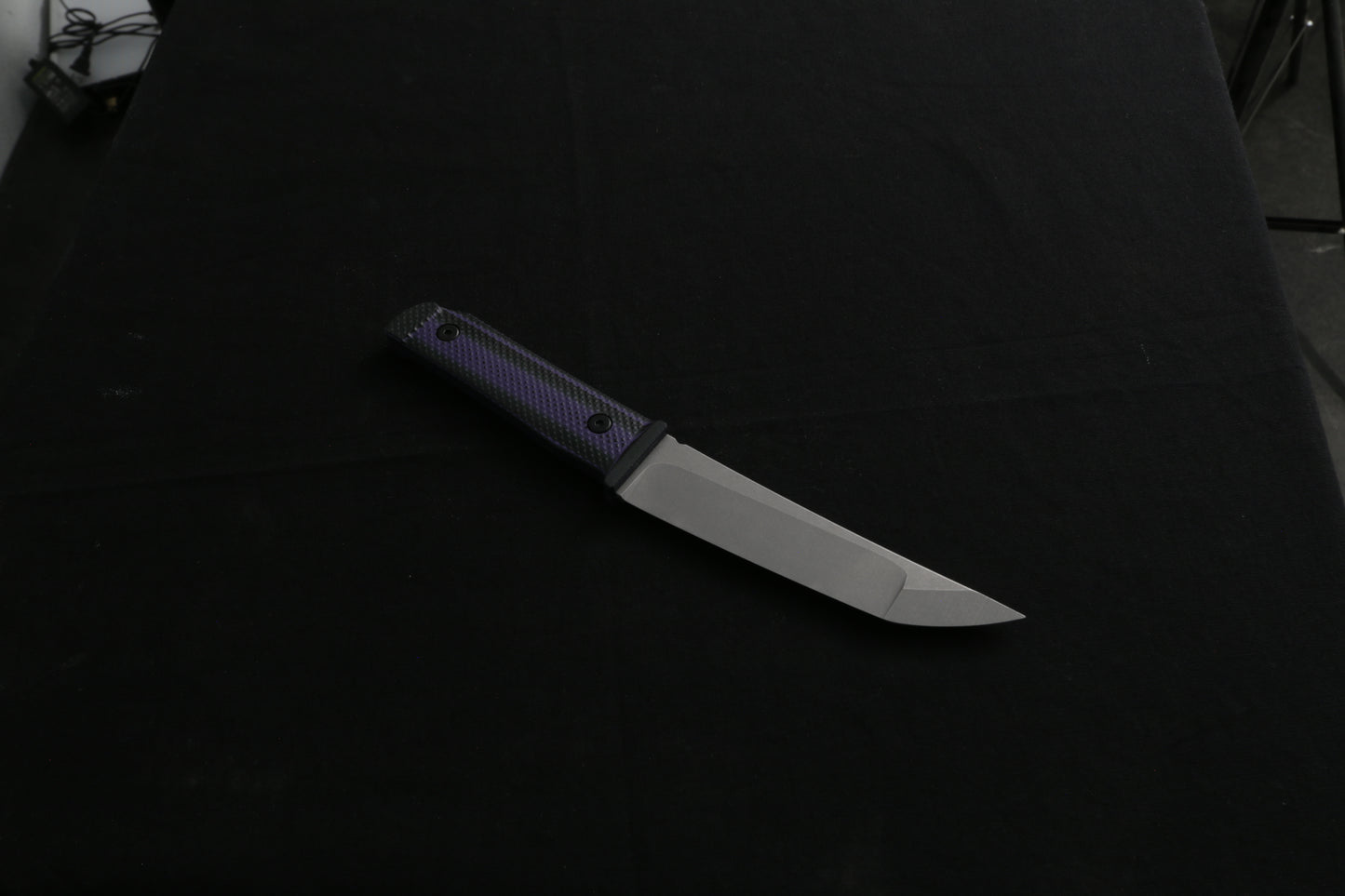 Knife with a black handle on a dark background