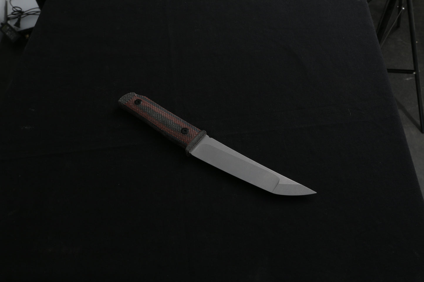 Knife with a wooden handle on a dark background