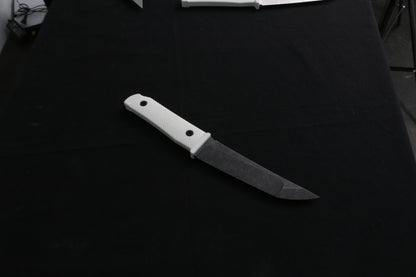 Knife with a white handle on a dark surface