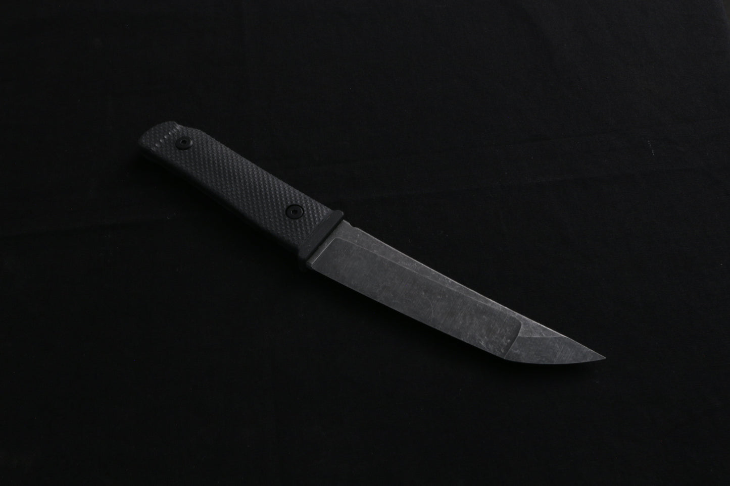 Knife on a dark surface with a blurred background