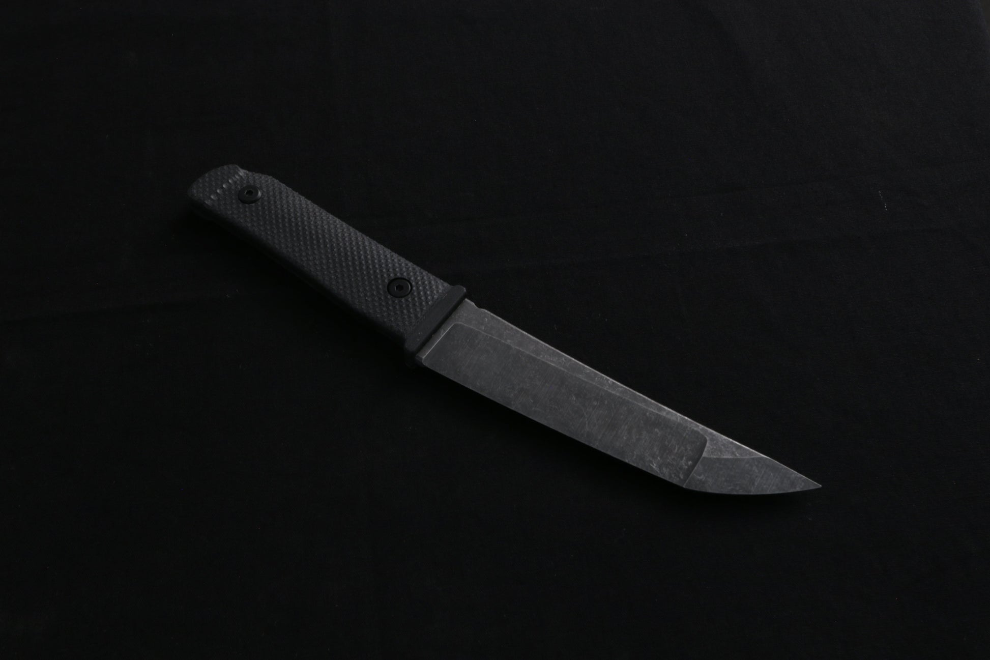 Knife on a dark surface with a blurred background