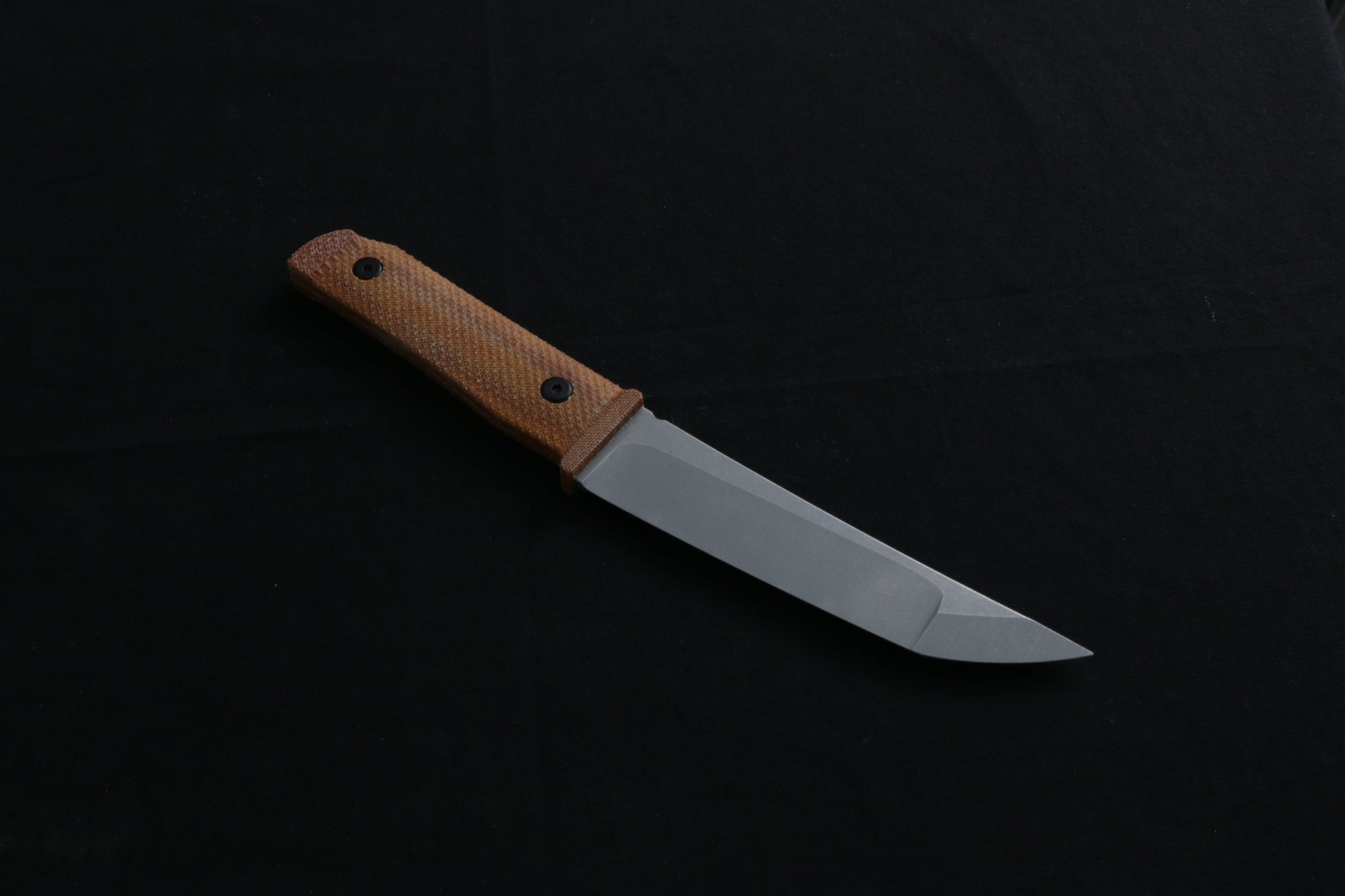 Knife with a brown handle on a black background