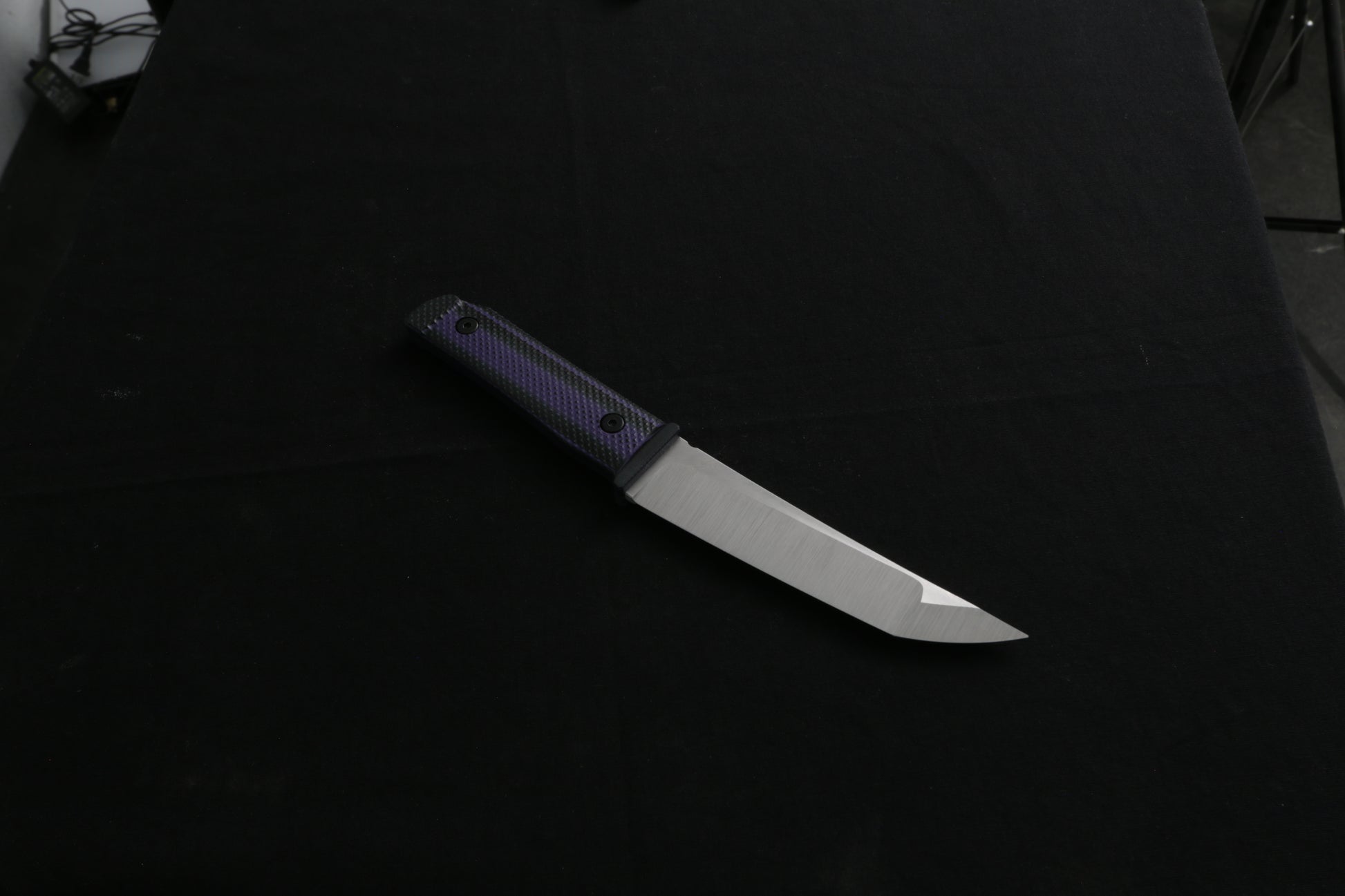 Knife with a black handle on a dark background