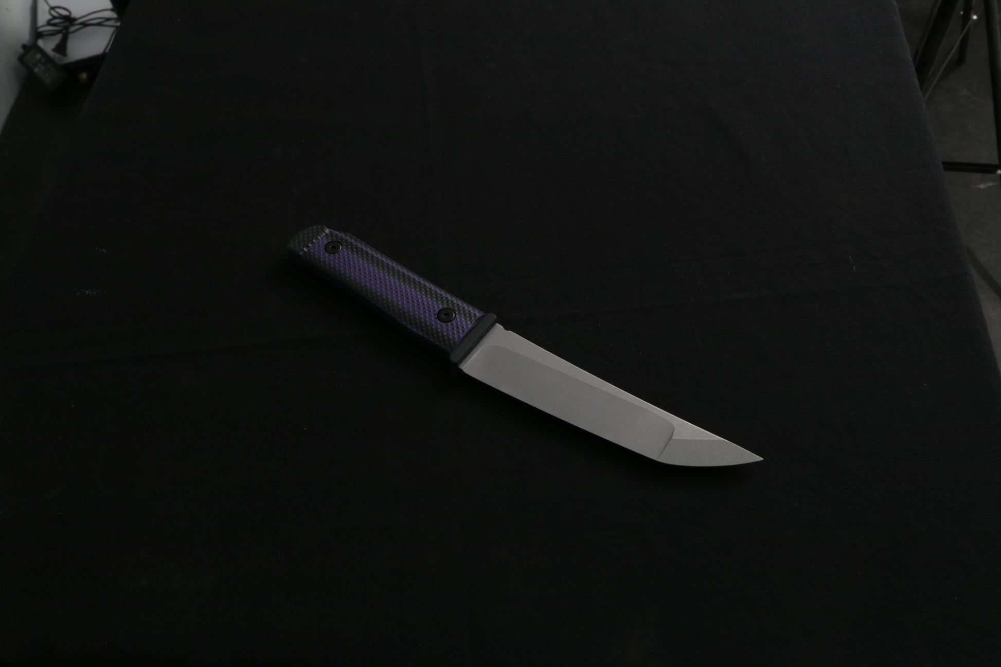 Knife with a black handle on a dark background