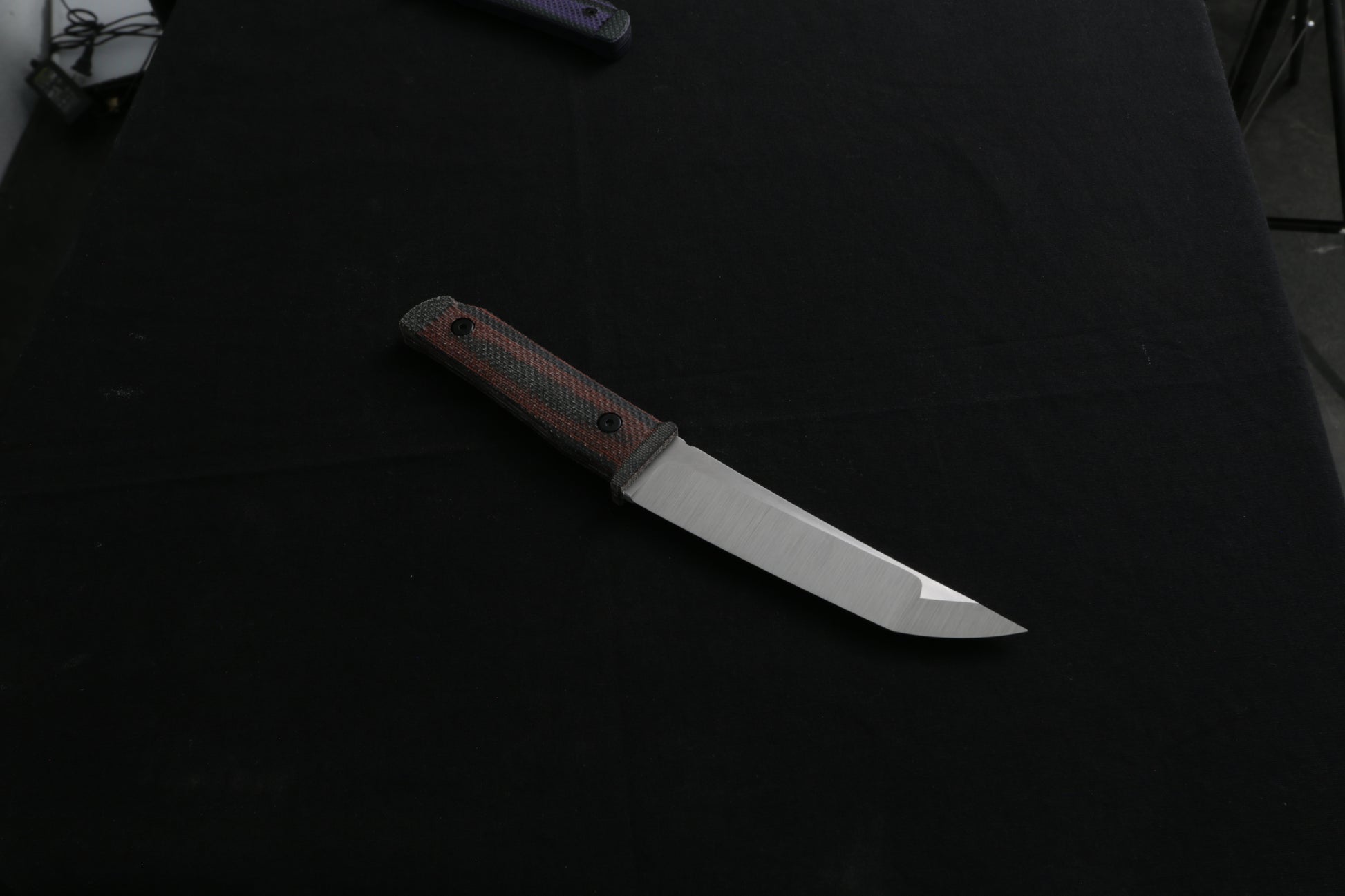 Knife with a brown handle on a black background